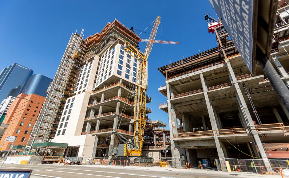 Construction site with high-rise buildings under construction and a large crane.